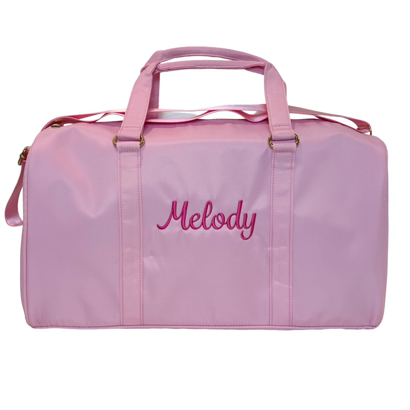 Pink duffle bag monogrammed with name. perfect for travel, after school sports, gym or overnight bag. Made of durable wipeable nylon, gold hardware, inner inside zipper pocket.