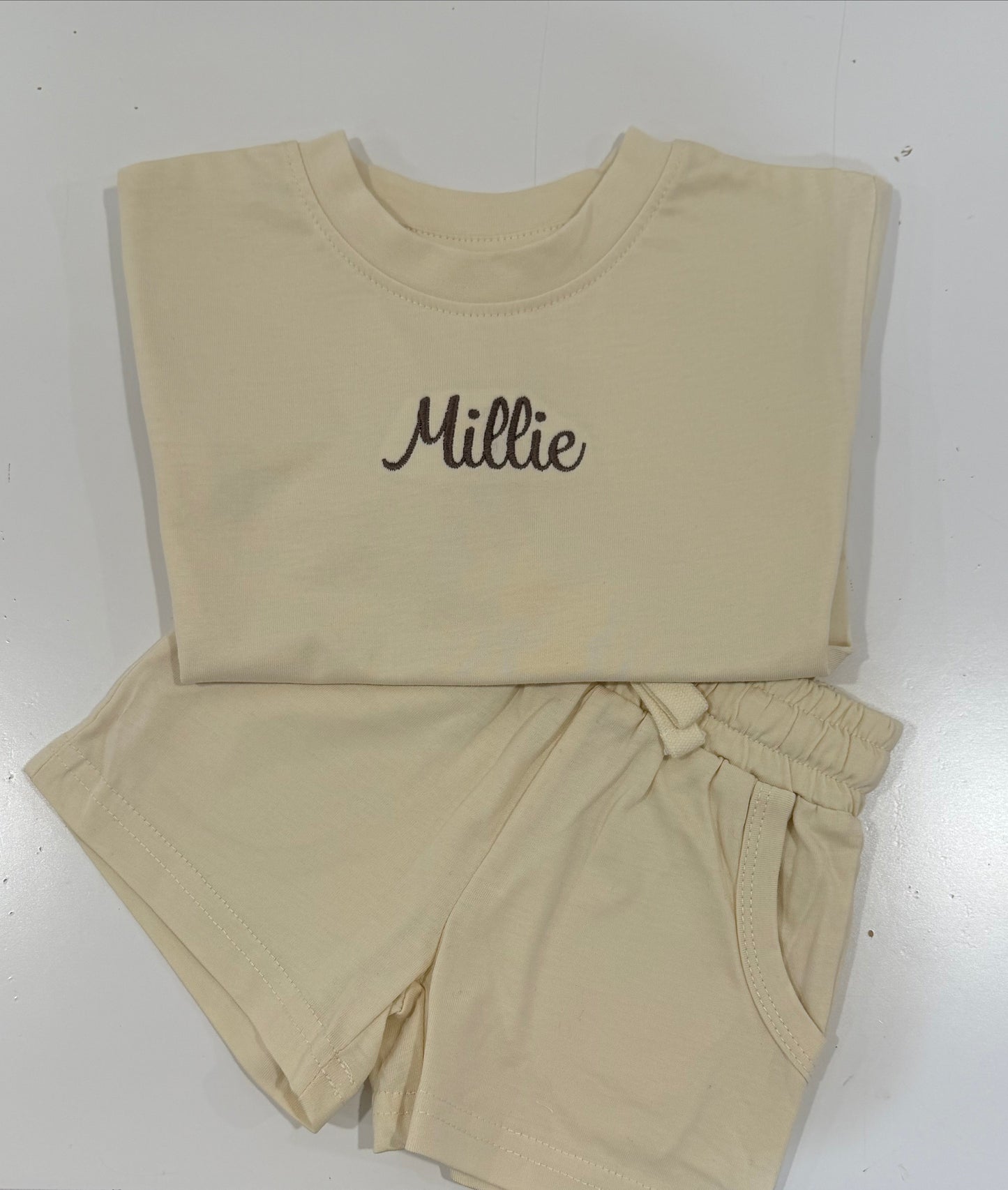 Beige kids shorts set with 'Millie' embroidered. 100% cotton drawstring waist and perfect for the next playdate. available in other colors 