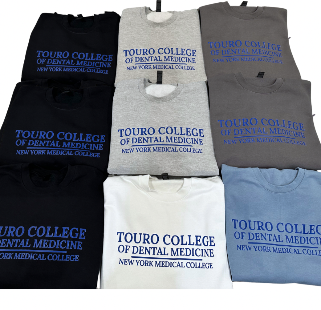 A collection of sweatshirts in black, gray, blue, and white, each with 'Touro College of Dental Medicine' printed on the front in blue or white text.