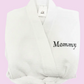 A white waffle-weave bathrobe with the word 'Mommy' embroidered in navy on the chest. Personalize this 36" robe for brides, gifts, moms, college gifts or for guest rooms. 