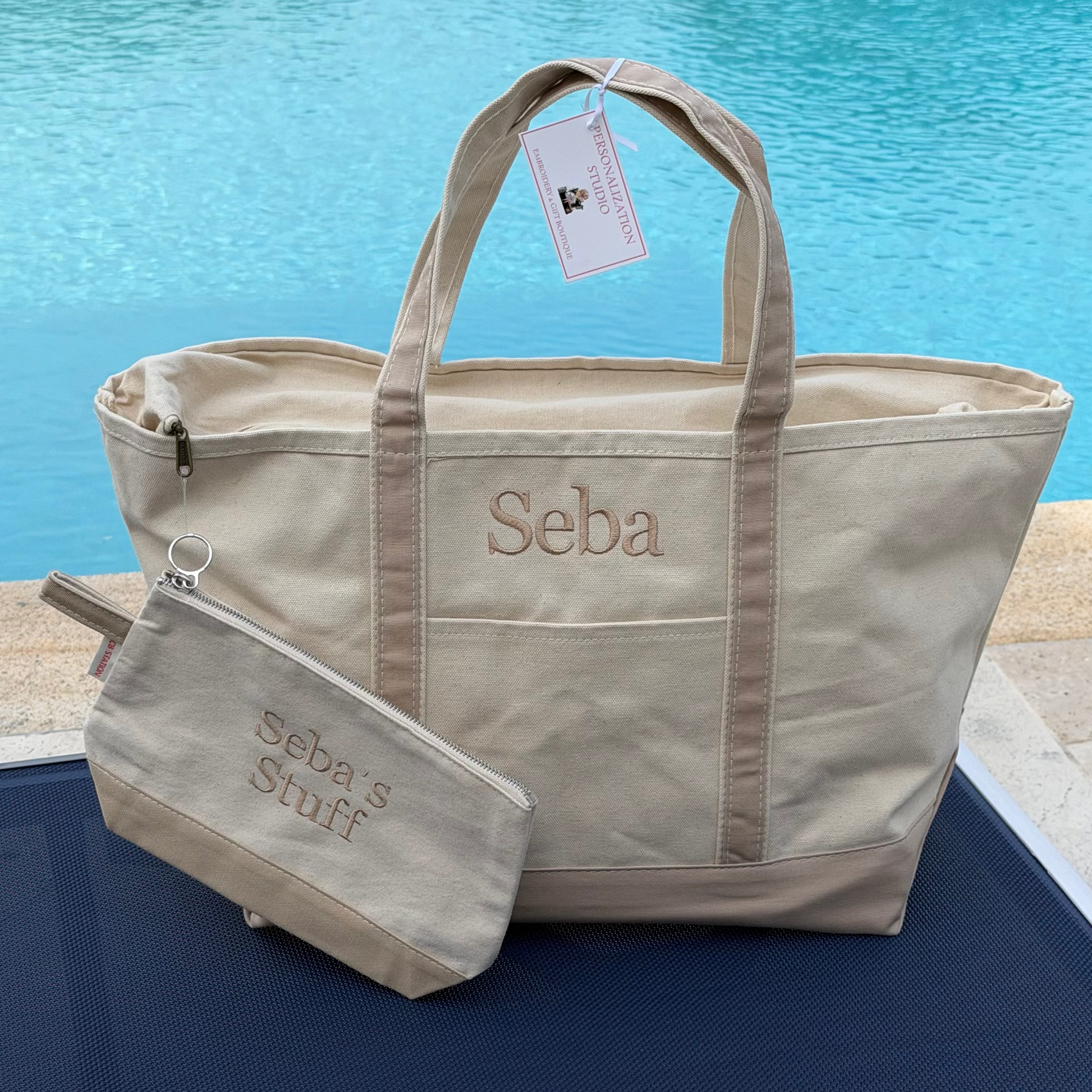Large classic CB Station Tote bag with to zipper enclosure.  name embroidered on front above outer pocket. additional accessory is small zippered pouch to match- sold separately.