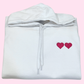 sweatshirt with custom embroidered hearts on left chest in hot pink